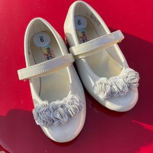 Cream colored ruffle detail and Velcro strap